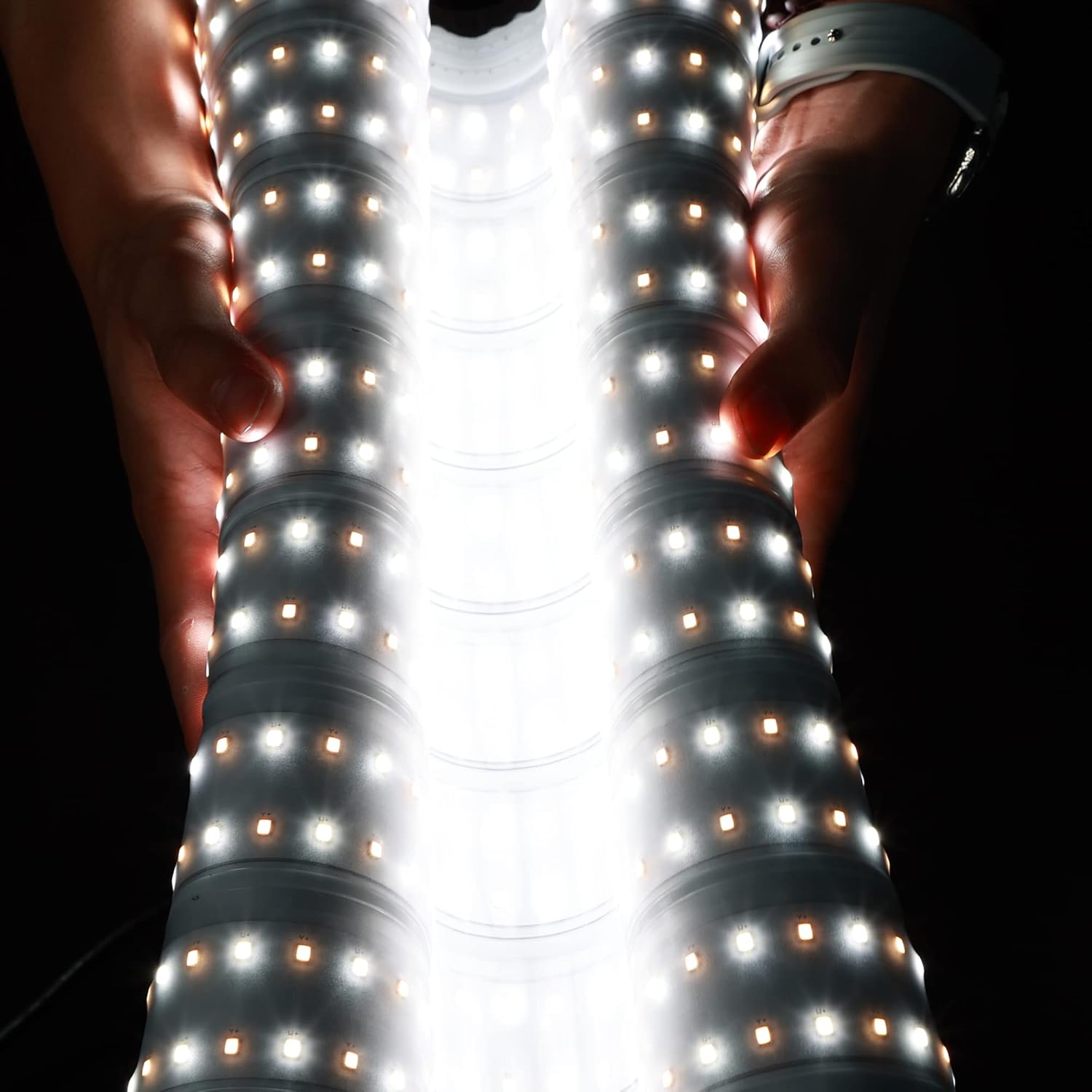 Hands demonstrating the flexibility of the waterproof LED light panel