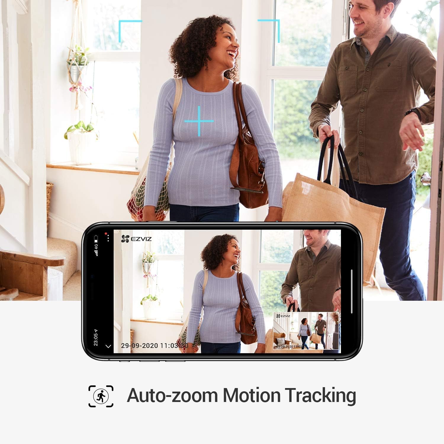 EZVIZ C6W camera demonstrating auto-zoom motion tracking, showing a couple entering a home with the camera's view on a smartphone screen tracking their movement.