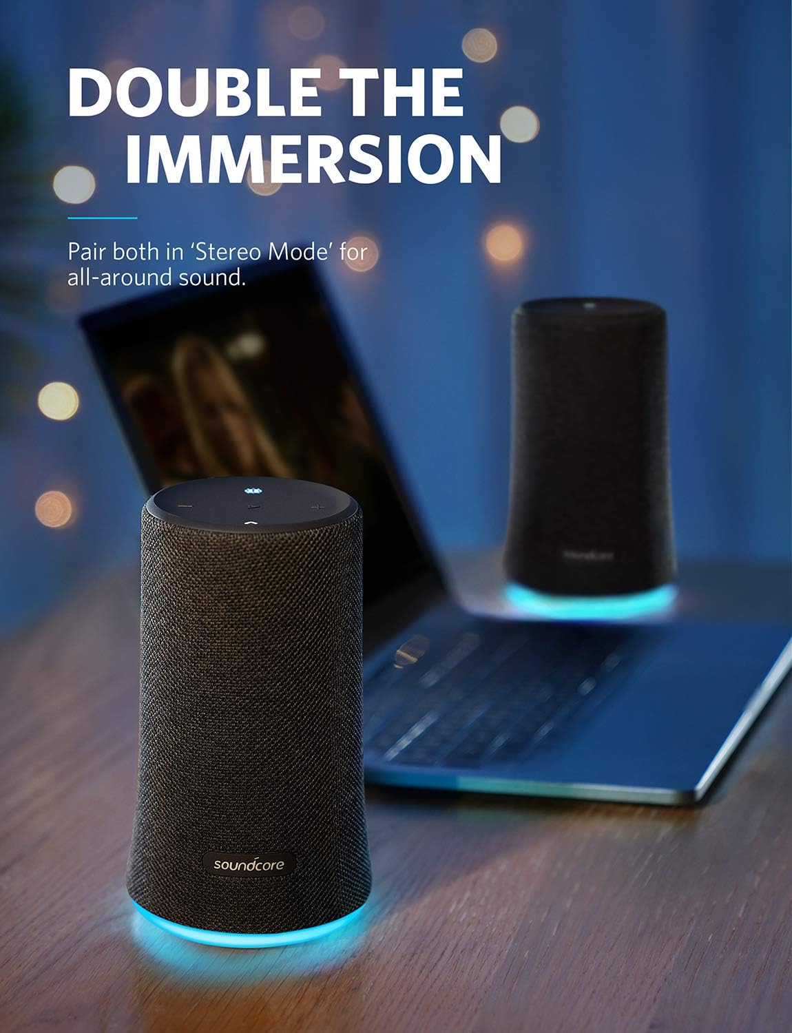 Two Soundcore Flare speakers paired in 'Stereo Mode' next to a laptop for immersive sound.