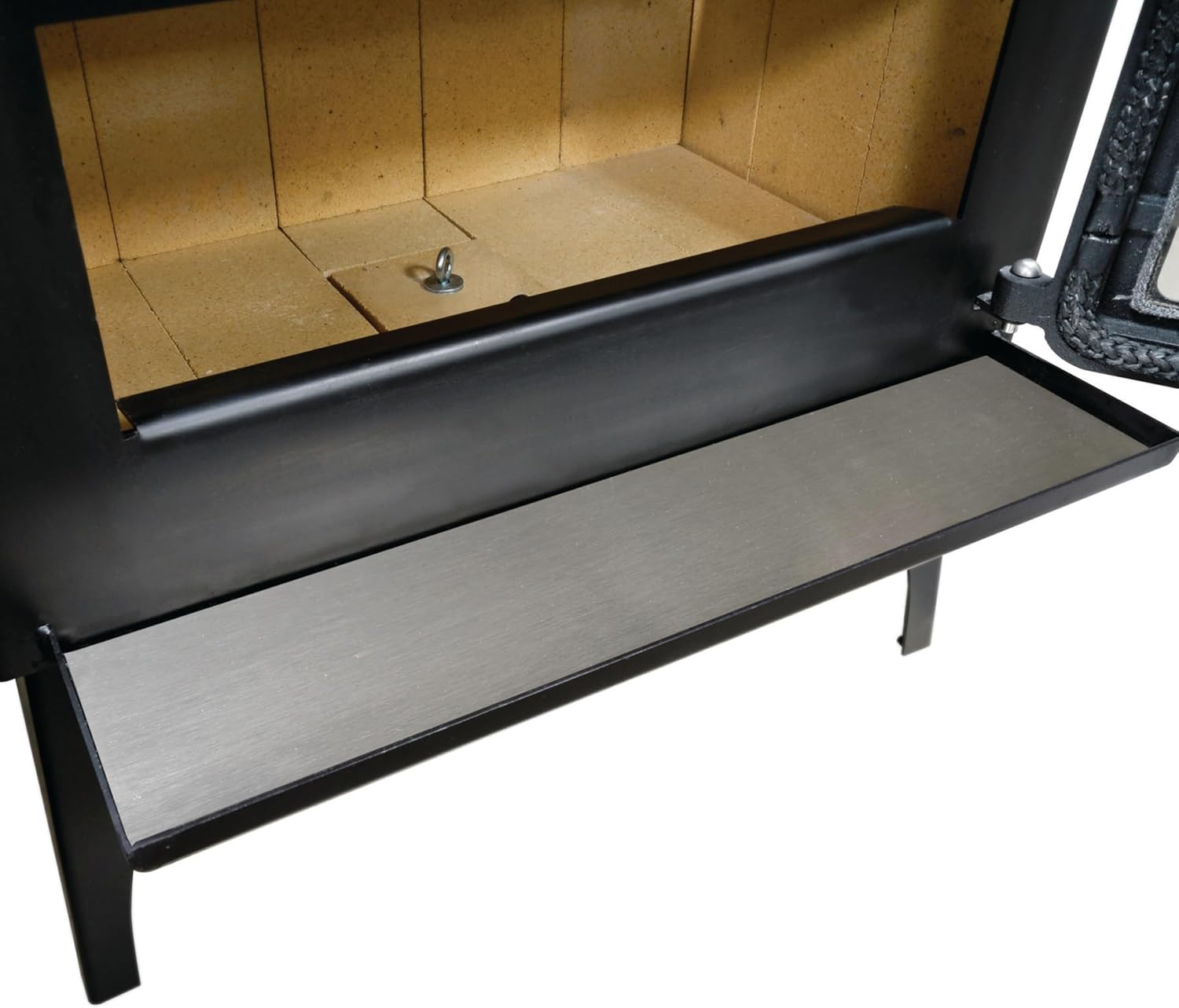 Close-up of the stainless steel ash lip extended from the front of the wood stove.