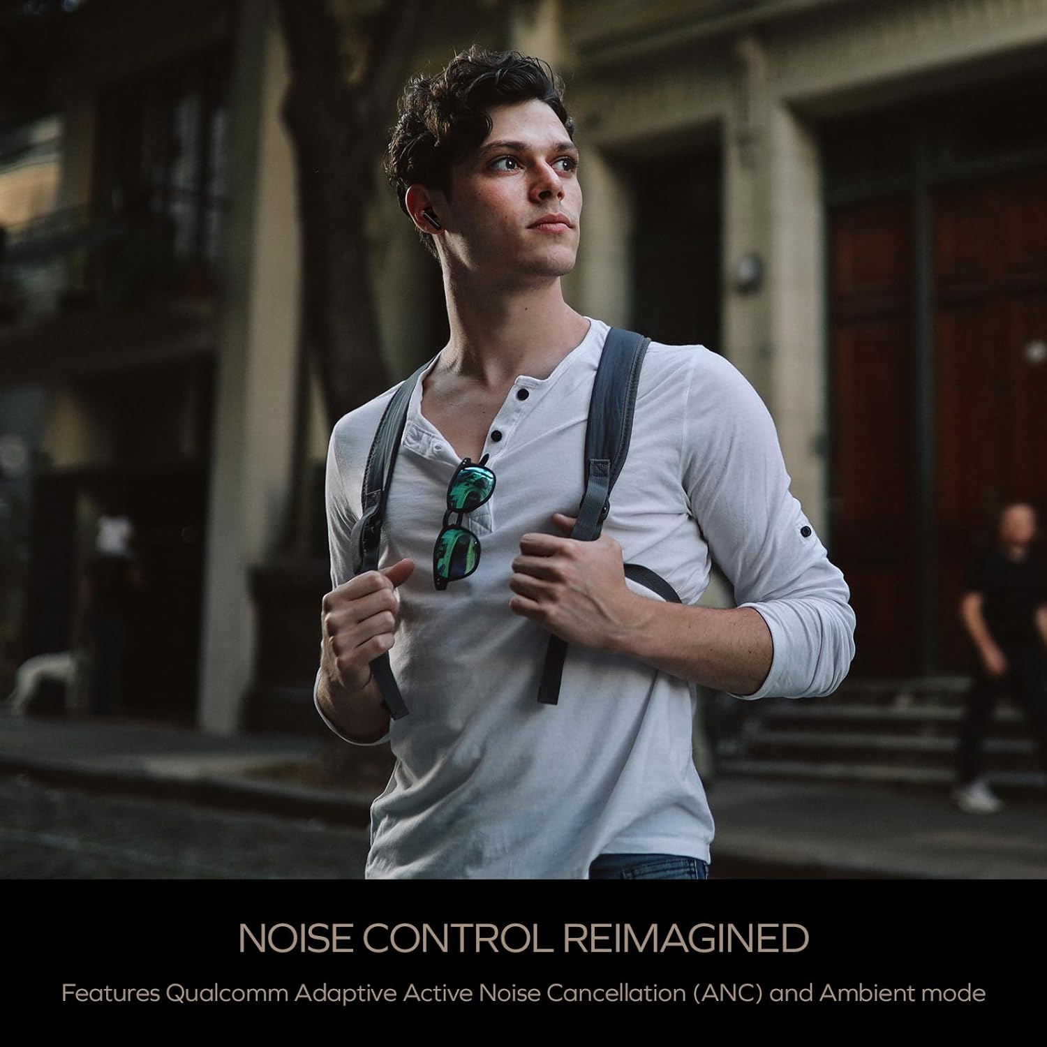 Person wearing Creative Aurvana Ace 2 earbuds in an urban environment, suggesting noise control features