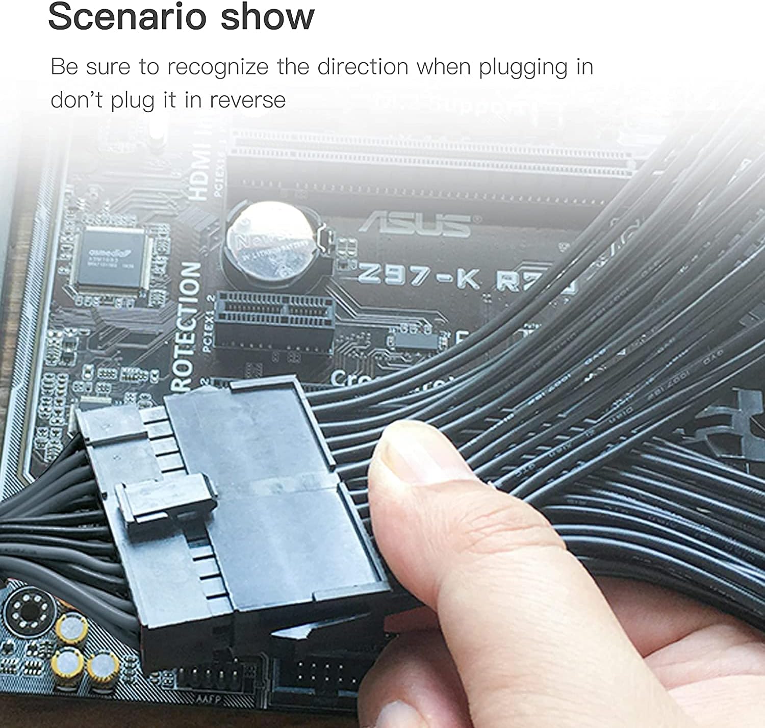Hand plugging a 24-pin connector into a motherboard