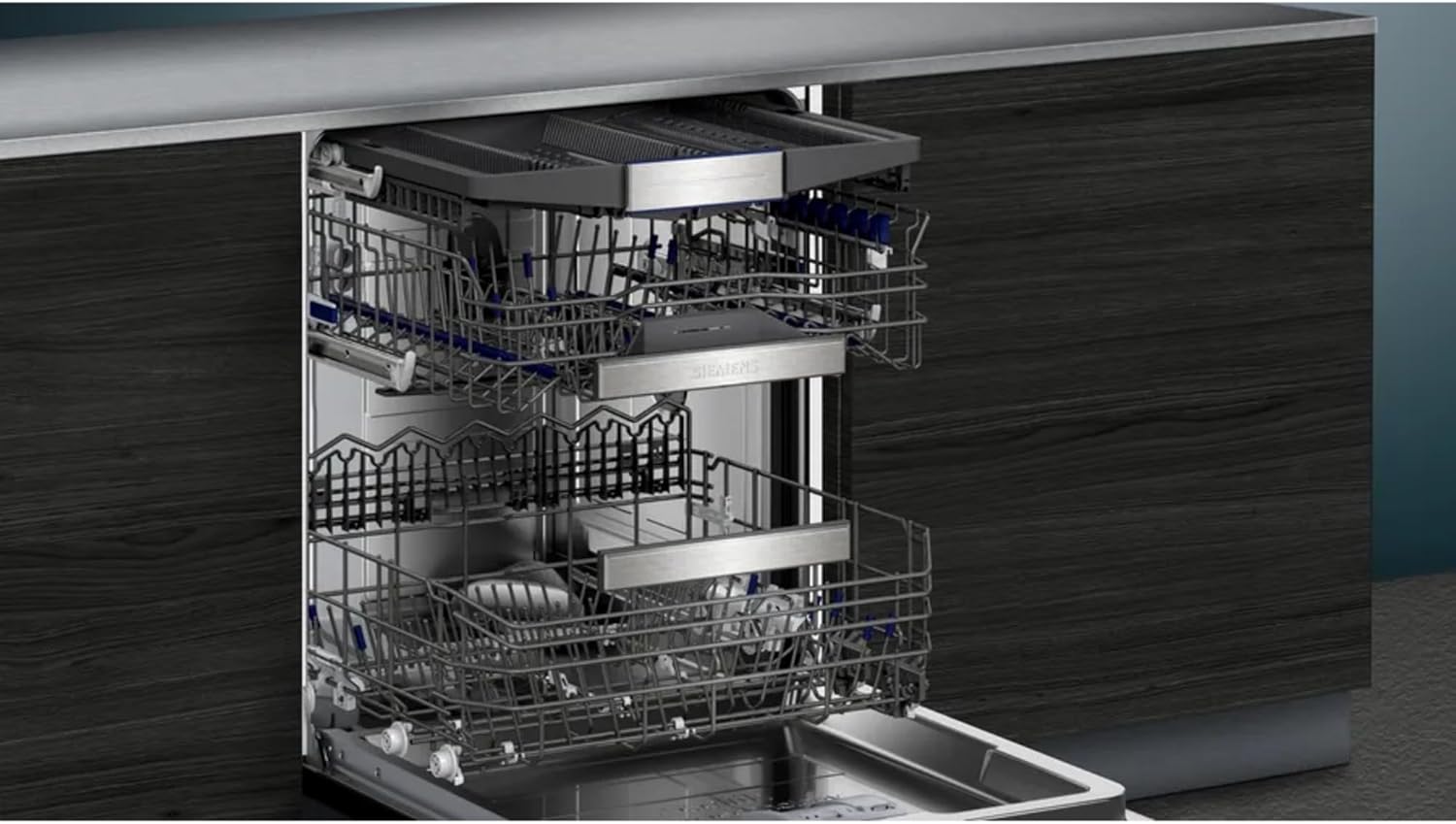 Interior view of the dishwasher showing the upper and lower baskets, with the upper basket adjusted for taller items.