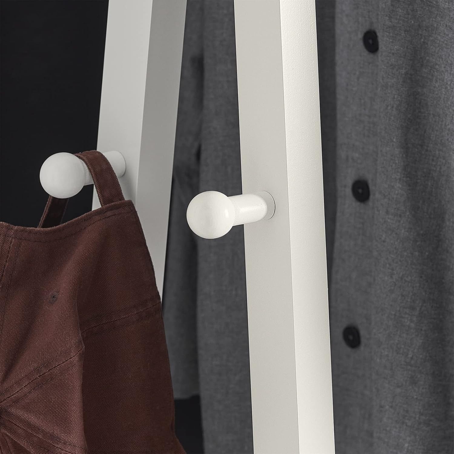 Close-up of the side hooks on the SoBuy FRG59-W Garment Rack, with a hat hanging.
