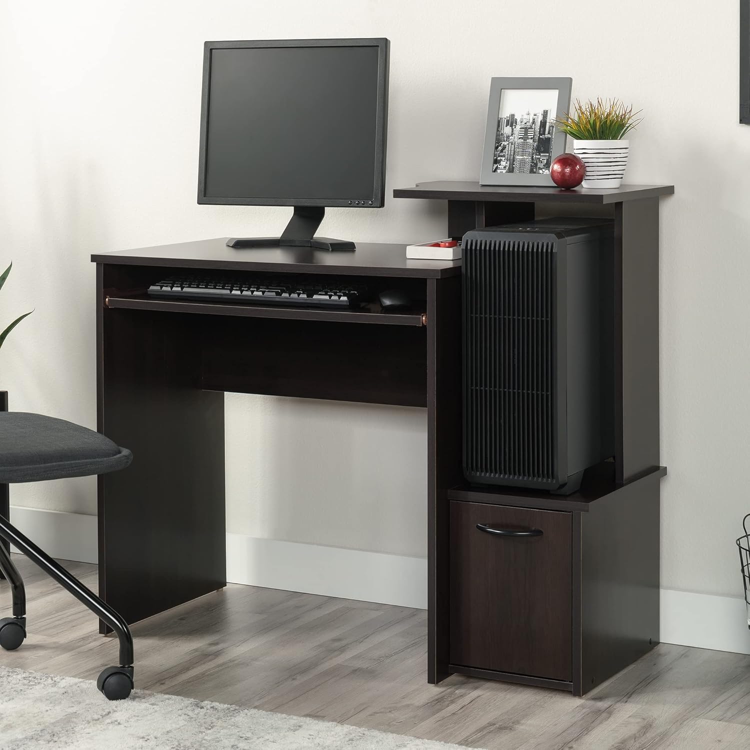 Sauder Beginnings Collection Computer Desk with a computer tower placed in its dedicated compartment.