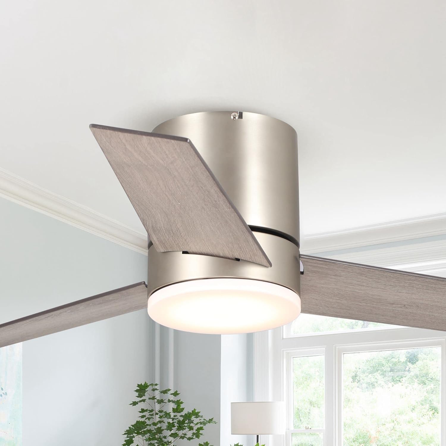 Close-up of the Vaczon ceiling fan's central hub and light, showing the semi-matte nickel finish and wood-grain blades