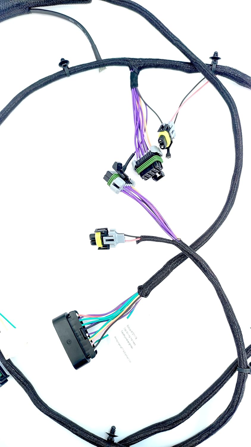 Close-up view of several multi-pin electrical connectors on the wiring harness, showing various wire colors and protective sheathing.