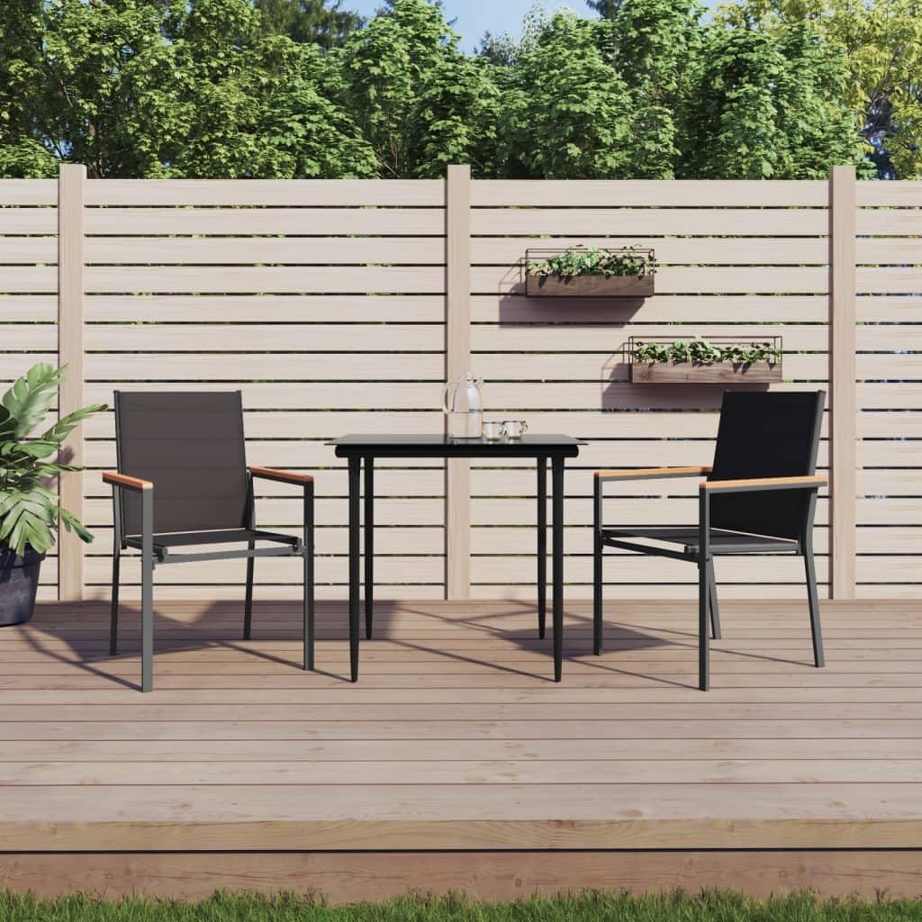 Two vidaXL patio chairs placed outdoors on a wooden deck with a small table between them, surrounded by greenery and a fence.