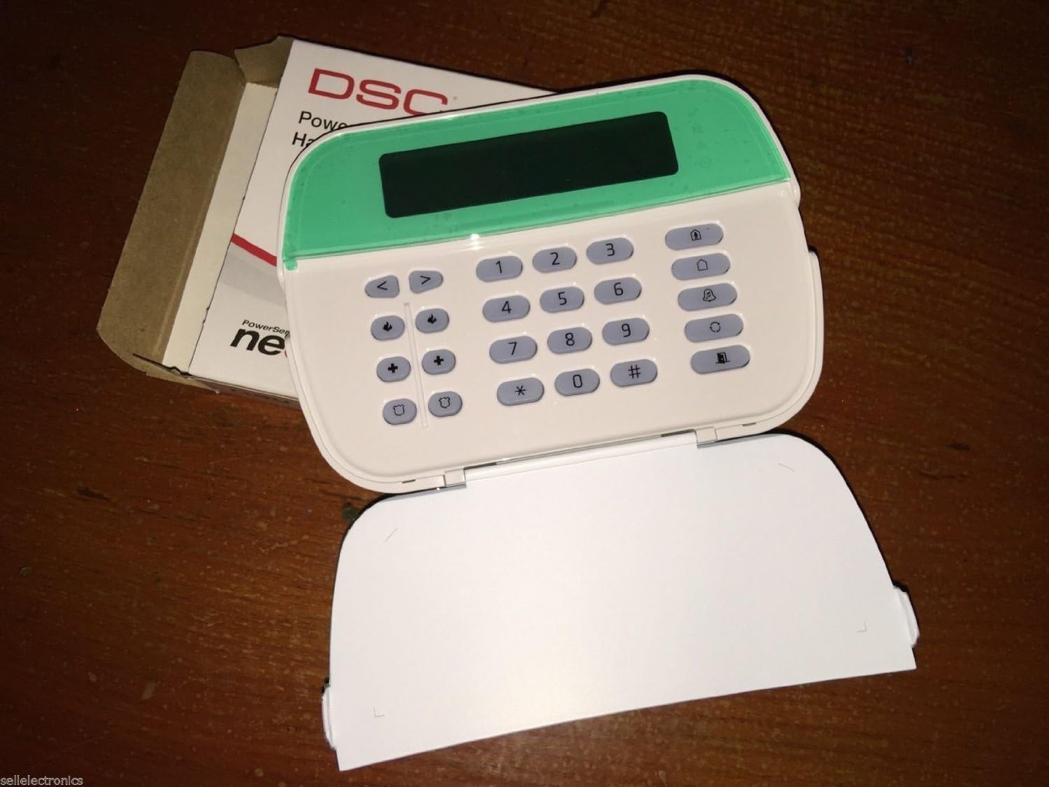 DSC HS2LCD Keypad with its cover open, revealing the numeric and function buttons.