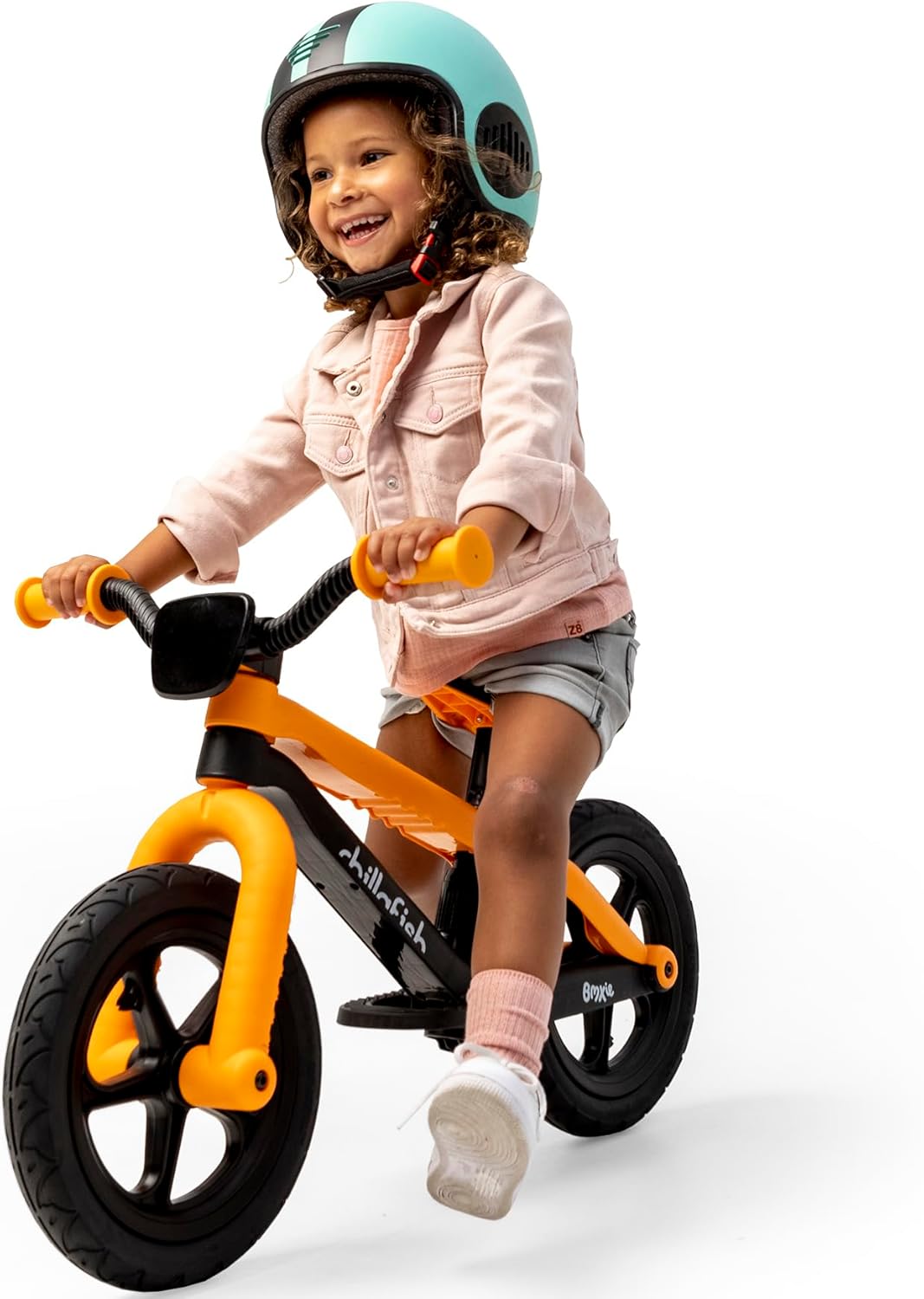 Another child riding the Chillafish Bmxie² balance bike with a helmet