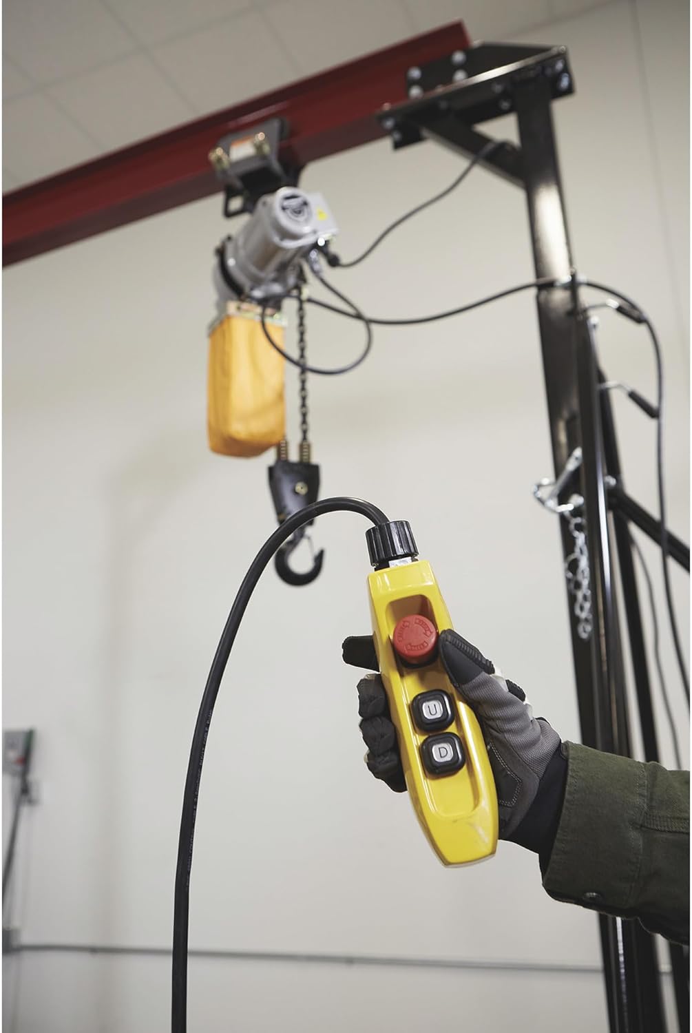 Hand holding the Strongway Electric Hoist remote control
