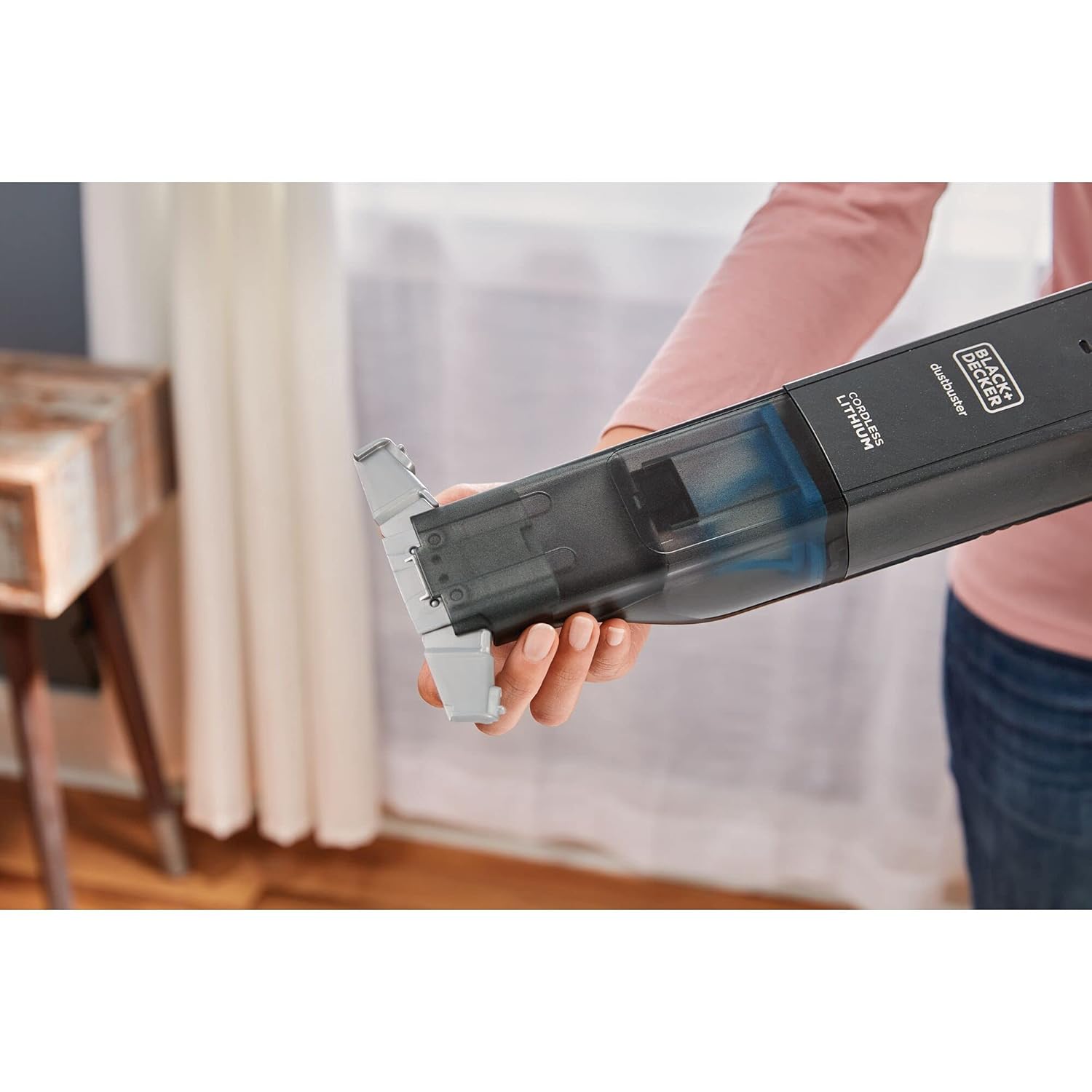 Hand holding the BLACK+DECKER HLVC320J11-QW vacuum, showing the nozzle mechanism
