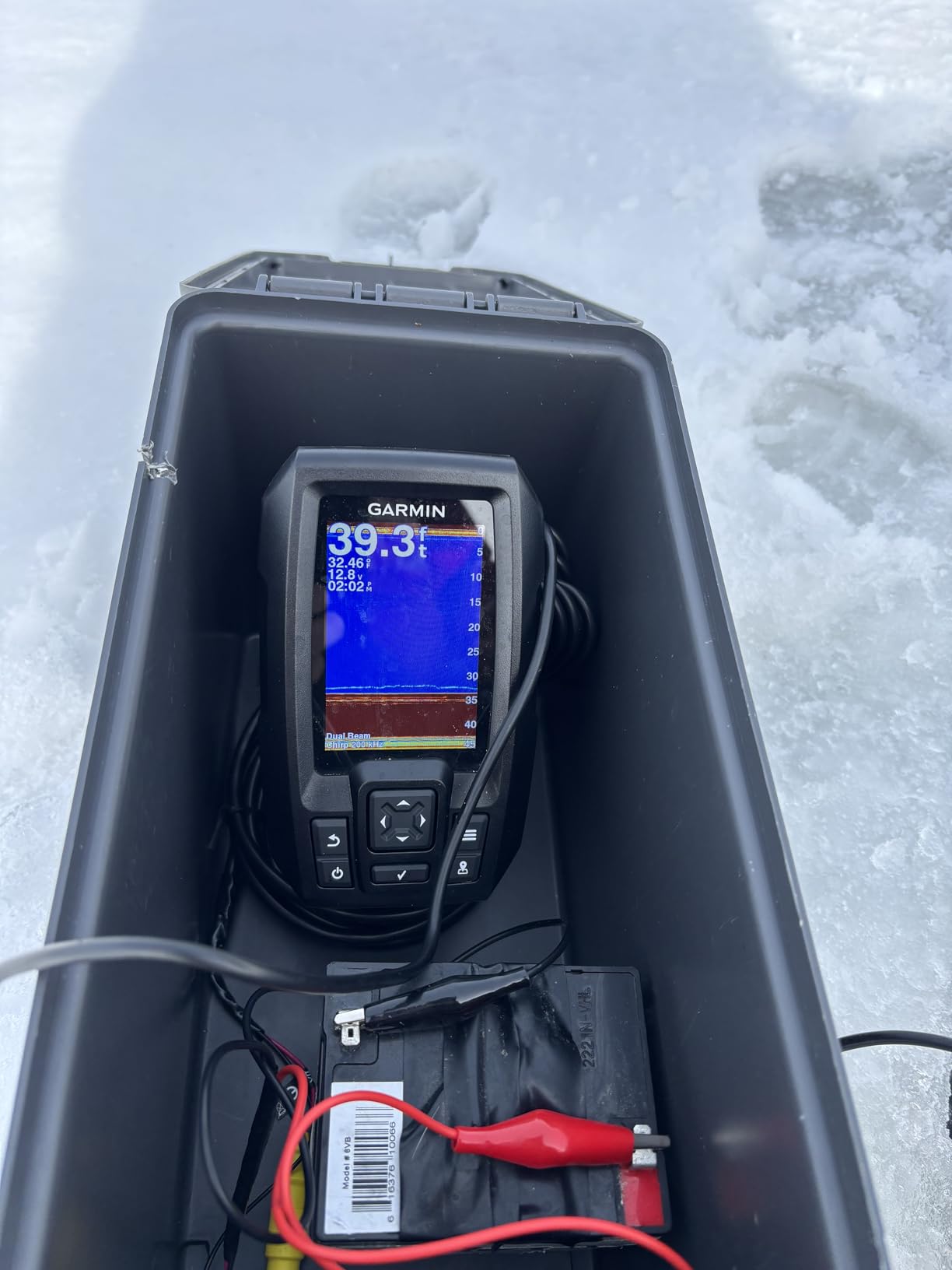 Garmin Striker 4 Fish Finder mounted on a boat console showing sonar display