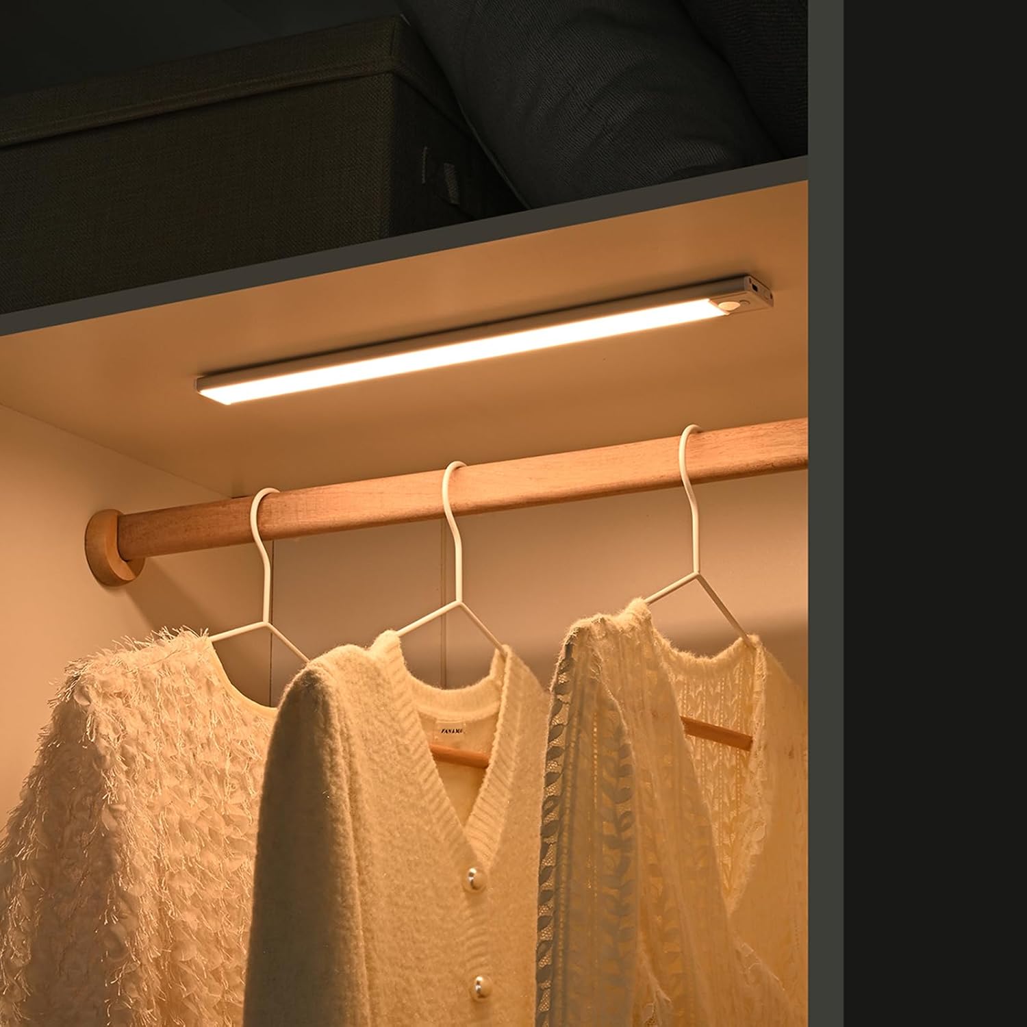 Luminous Pro Under Cabinet Light illuminating a closet with clothes.