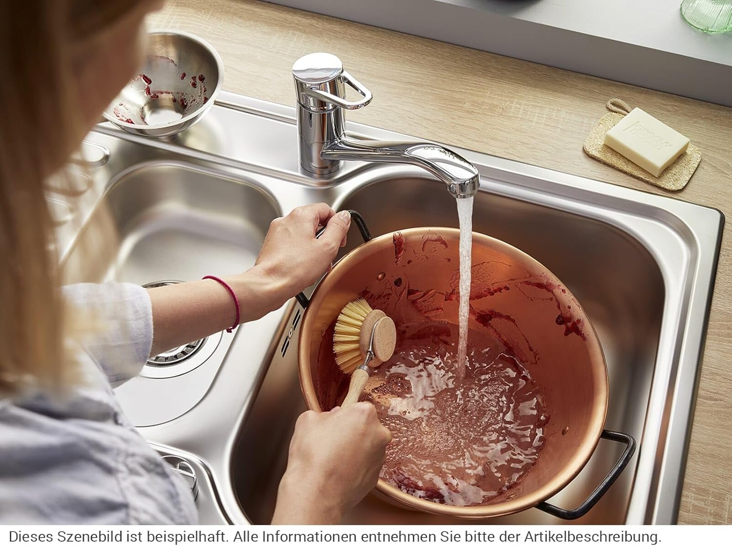 User cleaning a pot with BLANCO WEGA II Kitchen Tap