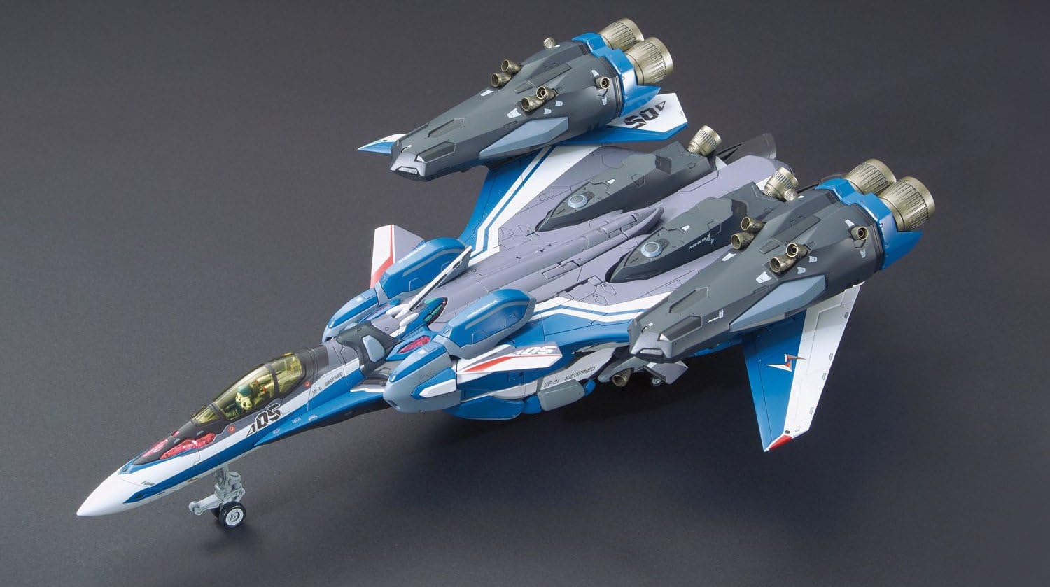 Overhead view of the VF-31J Super Siegfried in Fighter mode with Super Packs attached, showing additional weaponry and thrusters.