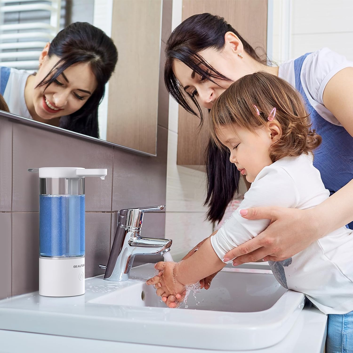 An adult assisting a child in washing hands using the automatic soap dispenser