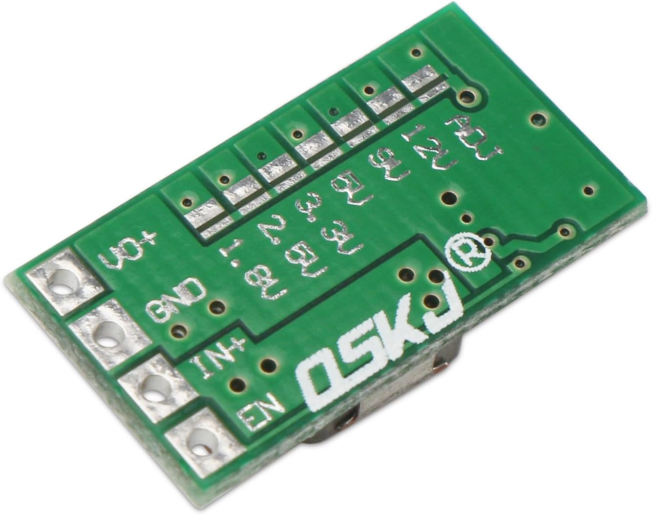 ქვედა view of the DROK buck converter module showing solder pads for fixed voltage selection (1.8V, 2.5V, 3.3V, 5V, 9V, 12V) and the ADJ pad.