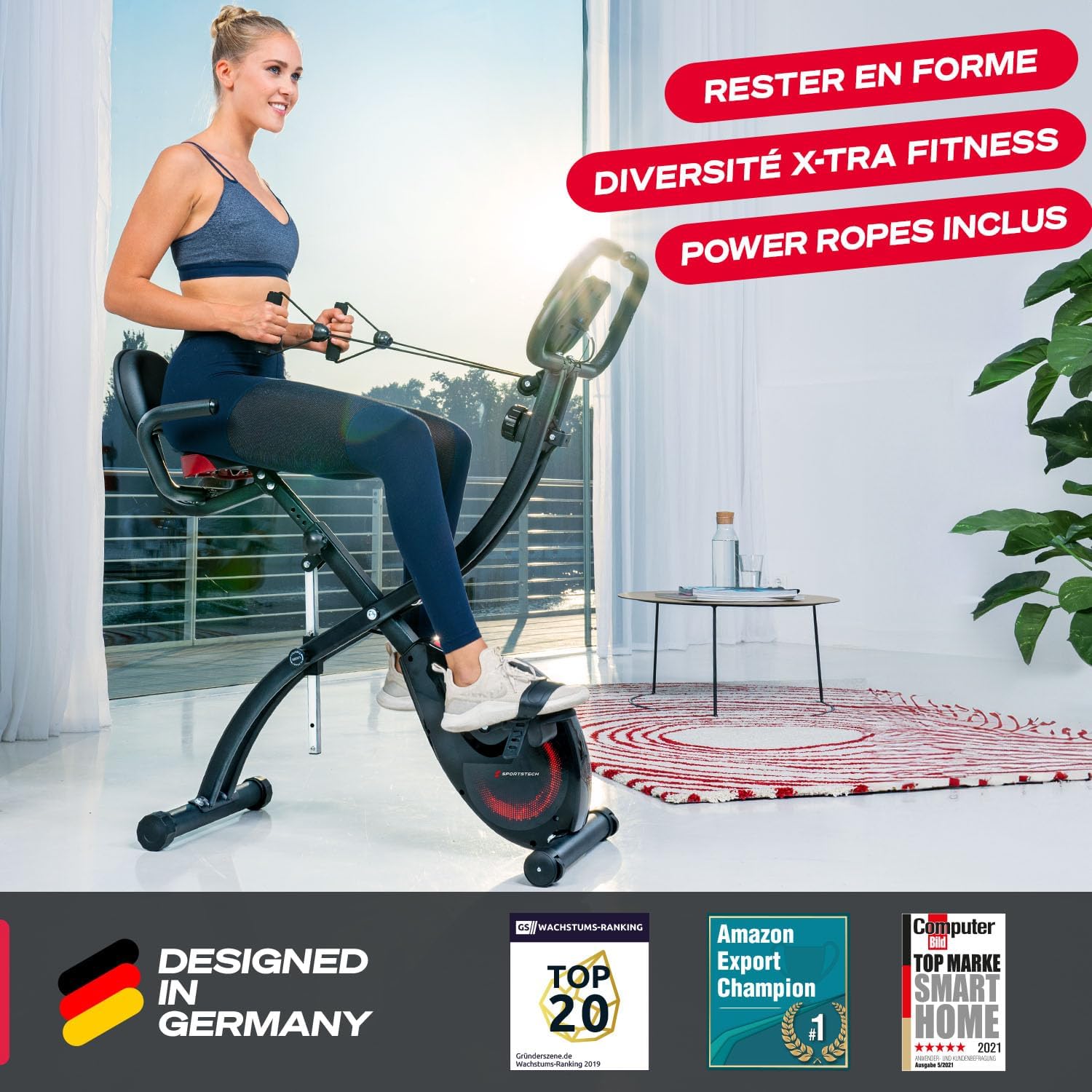 Sportstech F-Bike X150 exercise bike in upright position with user engaging resistance bands.