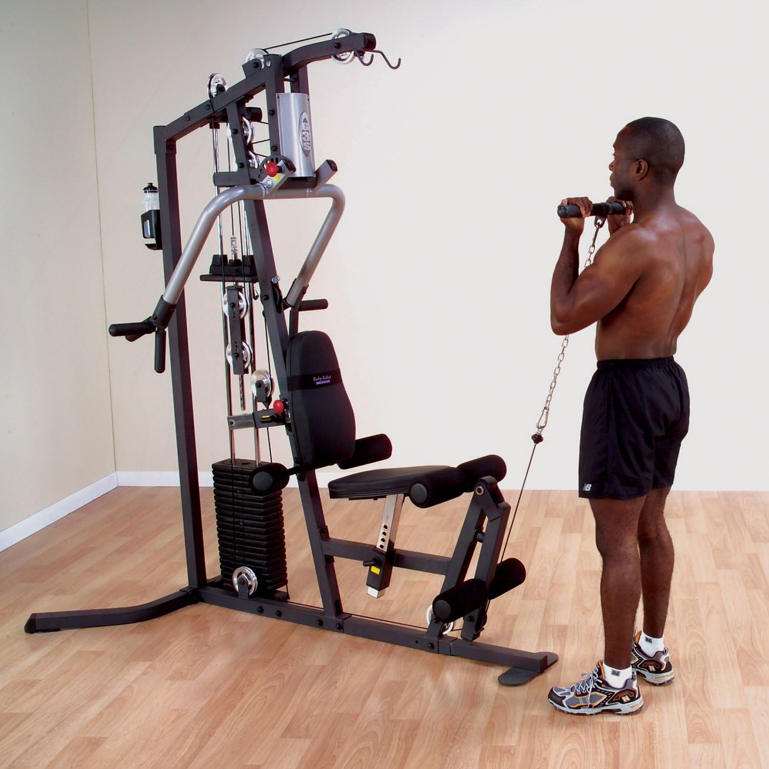 Man performing bicep curl on Body-Solid G3S Home Gym