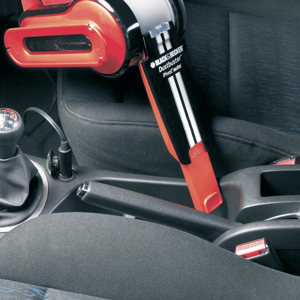 Person using BLACK+DECKER PAV1205 vacuum to clean between car seats