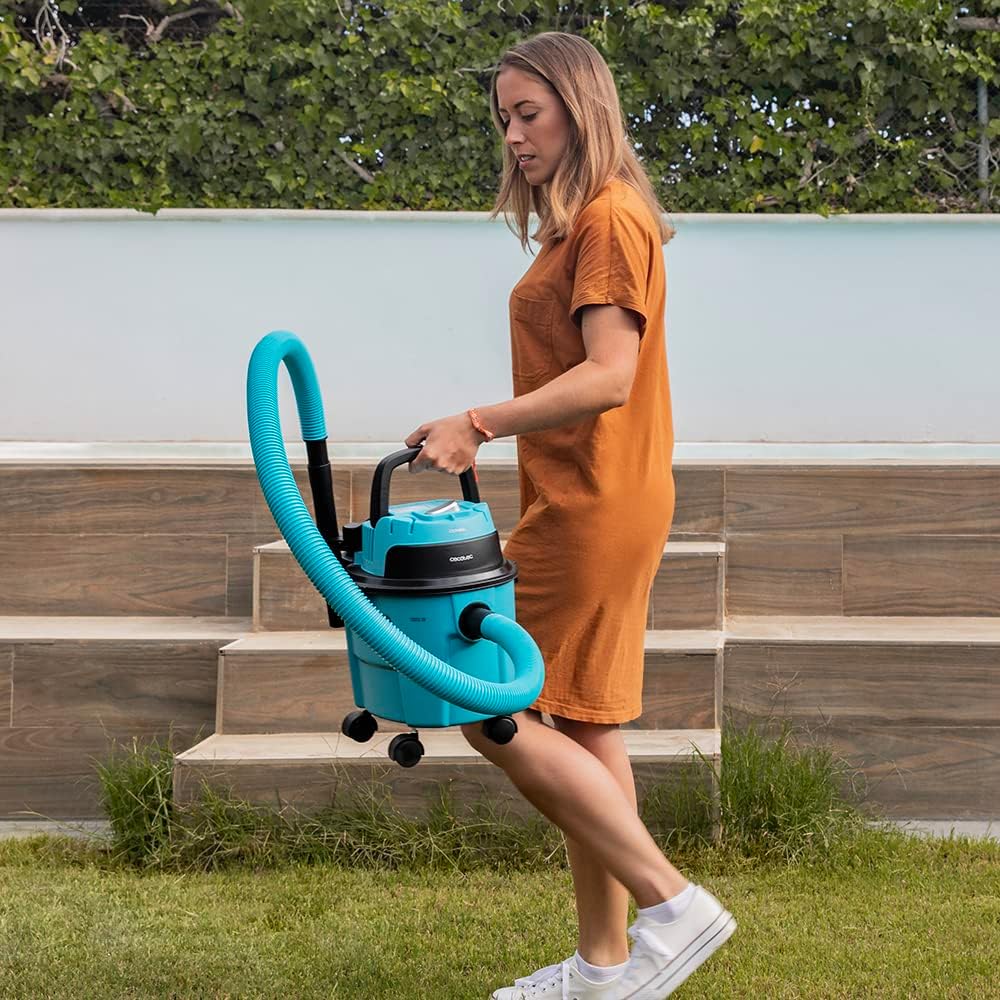 Person carrying the Cecotec Conga Rockstar Wet & Dry Compact Garden vacuum cleaner by its handle