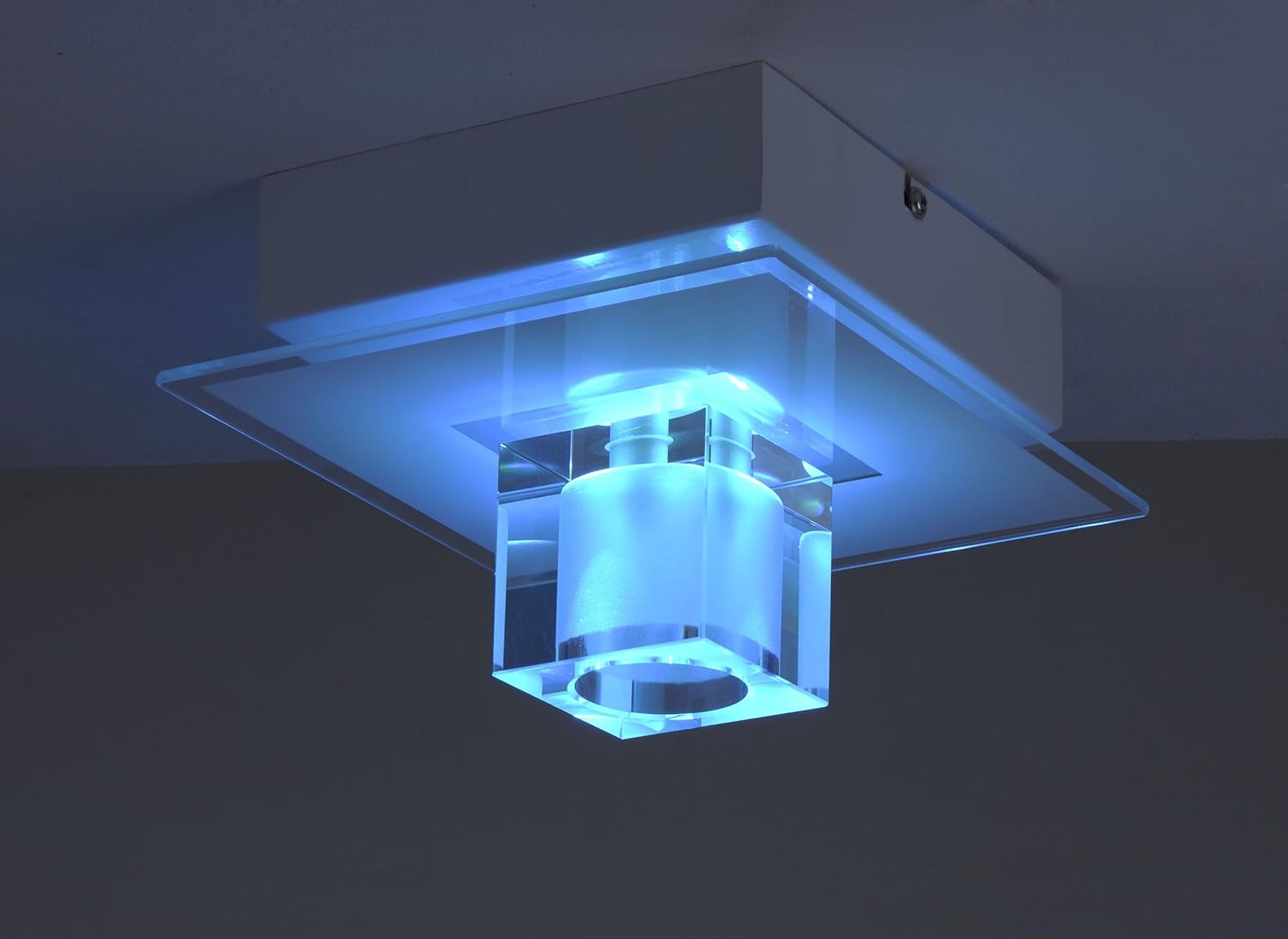 Leuchten Direkt TAKOS 50286-17 ceiling light illuminated with a bright cyan light.