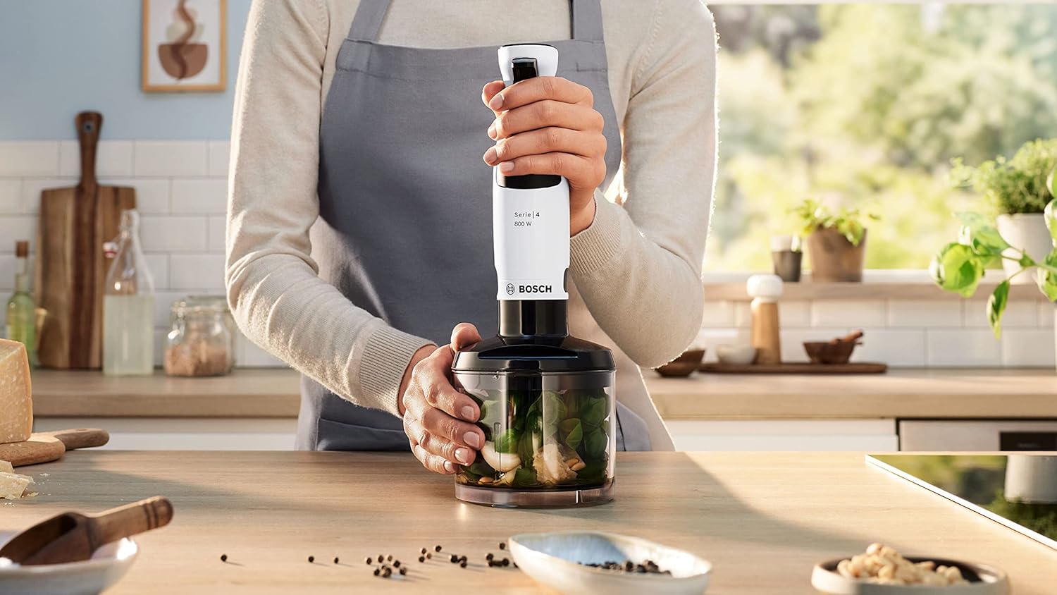 Person using the Bosch immersion blender with the chopper attachment