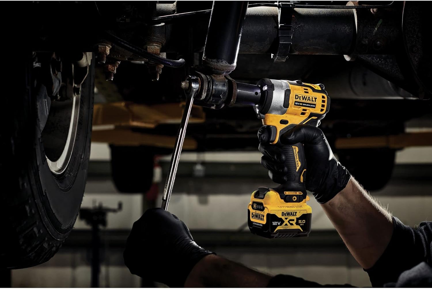 DEWALT impact wrench being used to loosen a bolt on a vehicle suspension