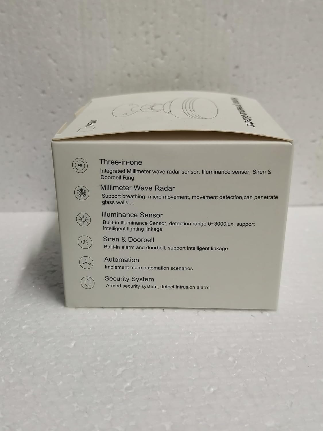 Side view of the product box detailing features like Millimeter Wave Radar, Illuminance Sensor, Siren & Doorbell, Automation, and Security System.