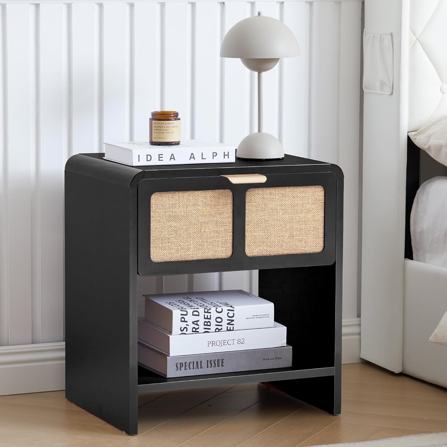 LEVNARY Mid-Century Modern Nightstand with Charging Station in black, featuring a fabric-like textured drawer and an open shelf, with a lamp and books on top.