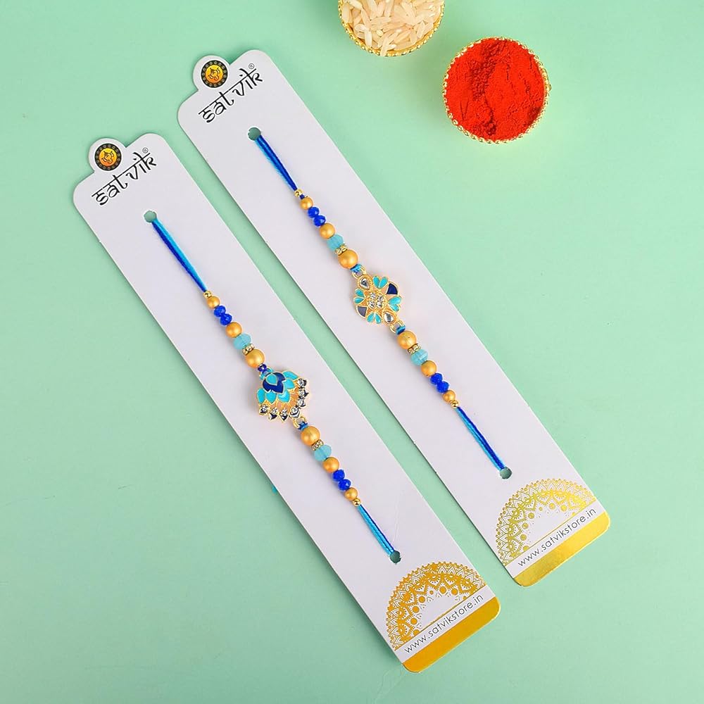 Purpledip Rakhi – Cesto Regalo Per Fratello: Ganesha In Marmo Chopra, 2 Rakhi, Roli Chawal Tika – Confezione Rossa Festiva