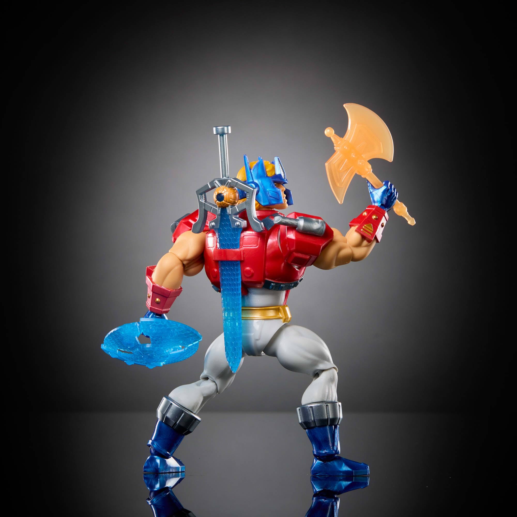 Masters of Universe Origins x Transformers - He-Man con armatura di Optimus Prime, action figure MOTU snodata da collezione con accessori e mini-fumetto inclusi, 6+ anni, JGT18