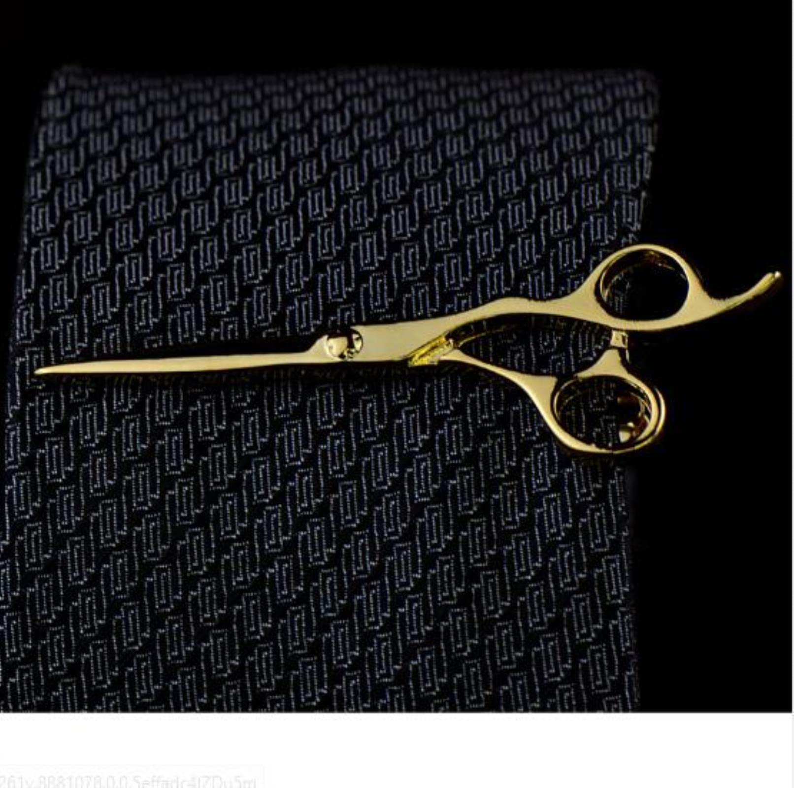 A top-down comparison shot of three different tie widths (standard, narrow, and skinny) each paired with a perfectly sized gold-tone tie clasp. The clasps stop just before the edge of the ties. Clean, light grey textured background, sharp focus on the metal finish.