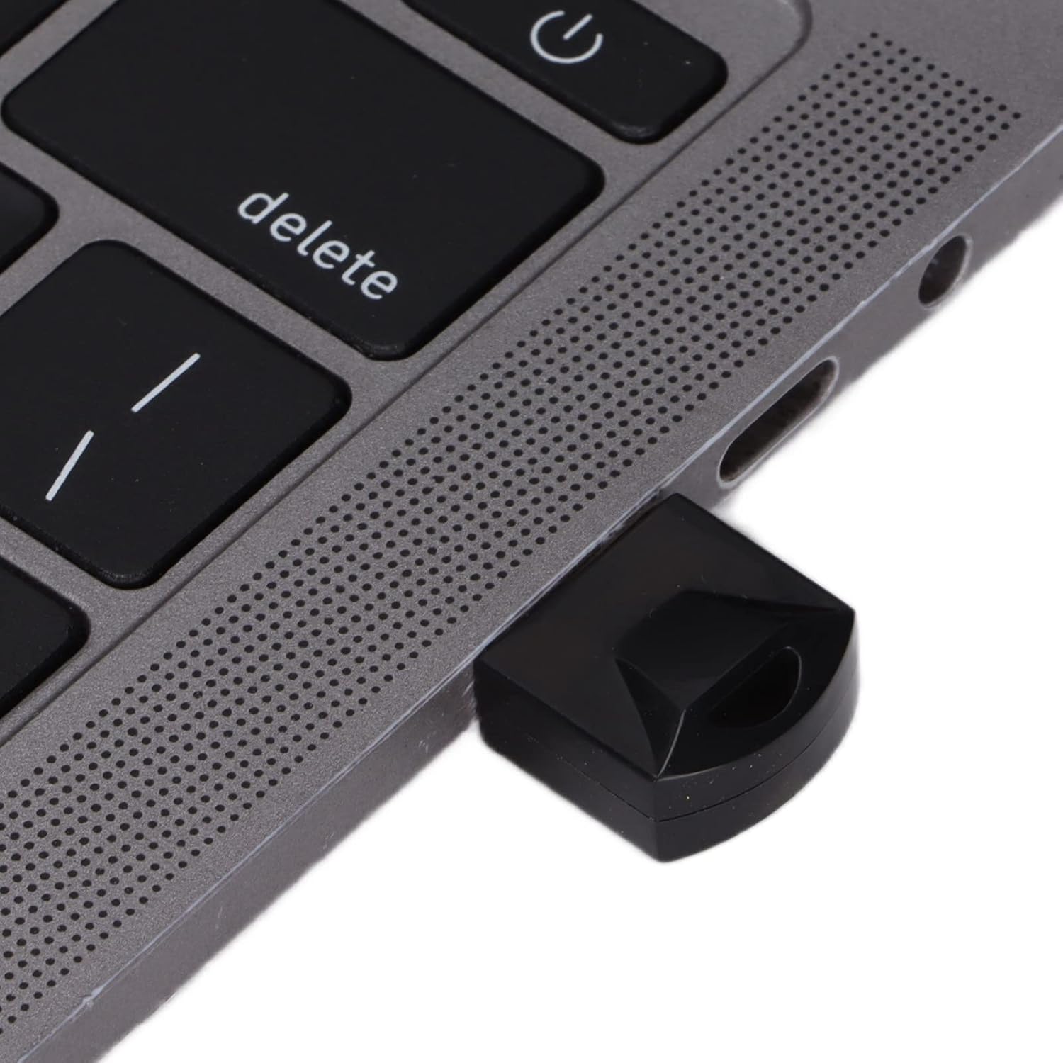 Close-up of USB Bluetooth adapter plugged into laptop