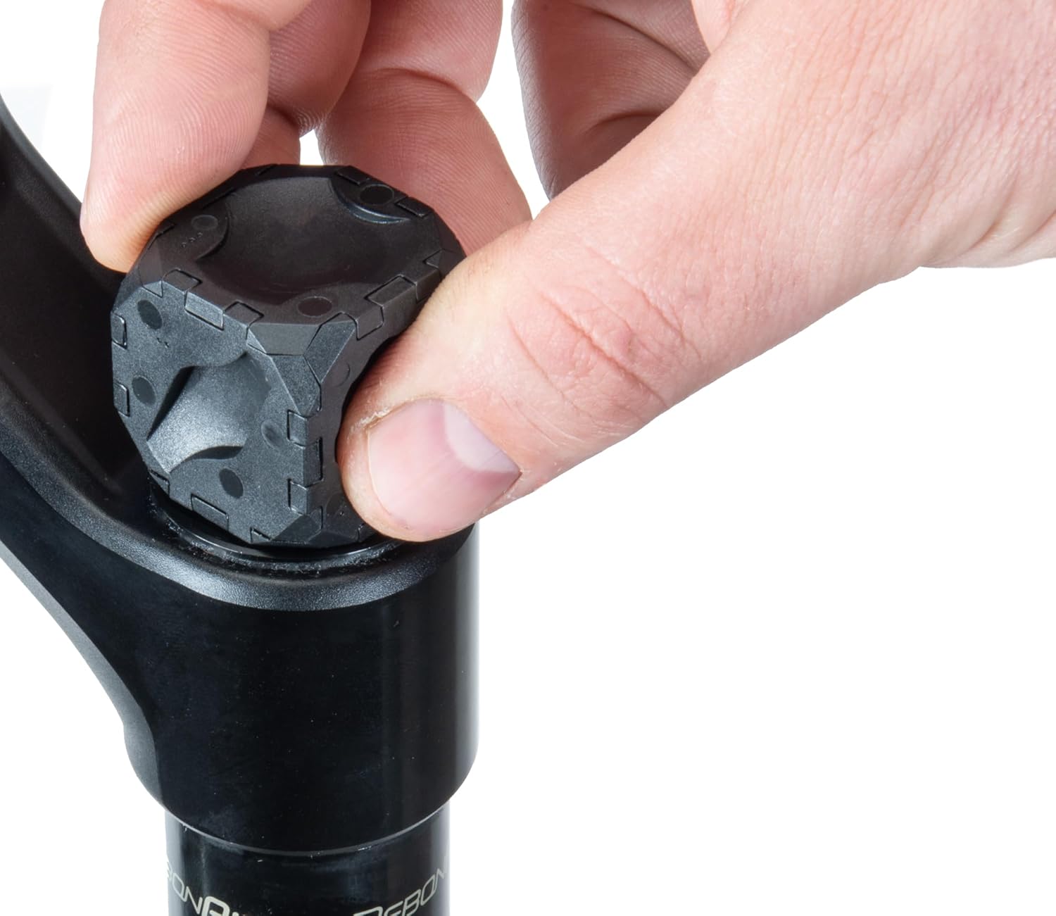 Hand rotating the Park Tool FCT-1 to loosen a bicycle suspension fork cap.