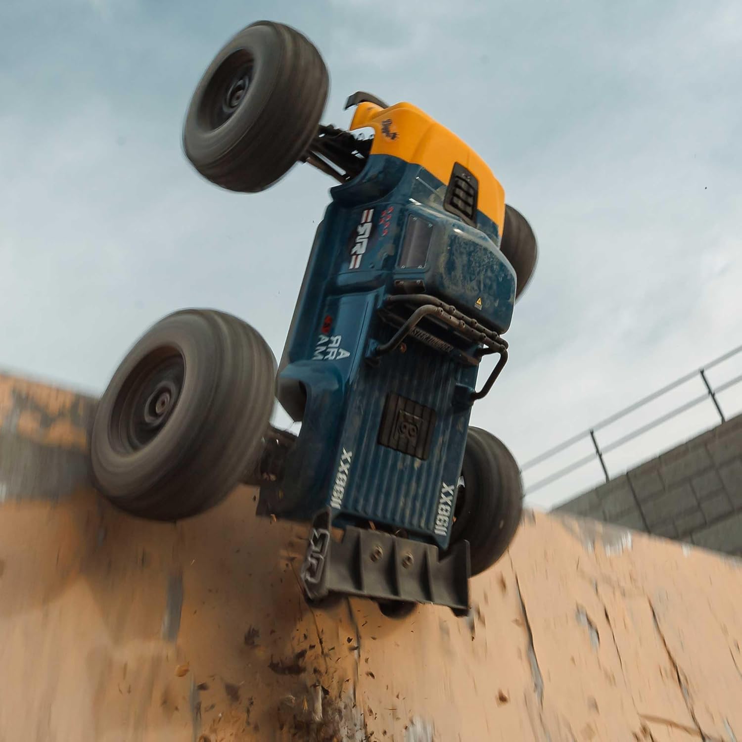ARRMA Notorious RC truck performing a vertical stunt against a wall.