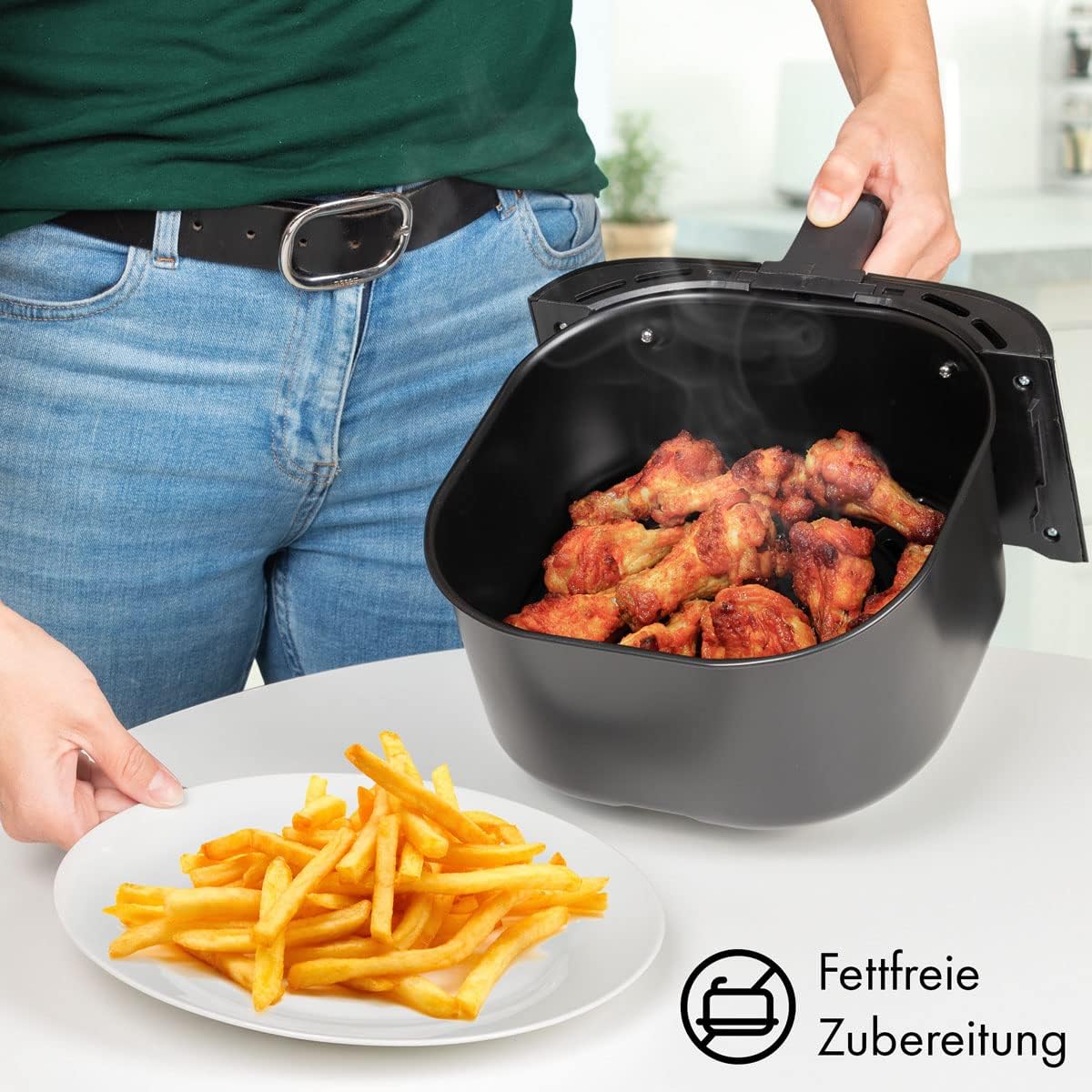 Profi Cook Air Fryer basket with cooked chicken and fries, indicating fat-free preparation