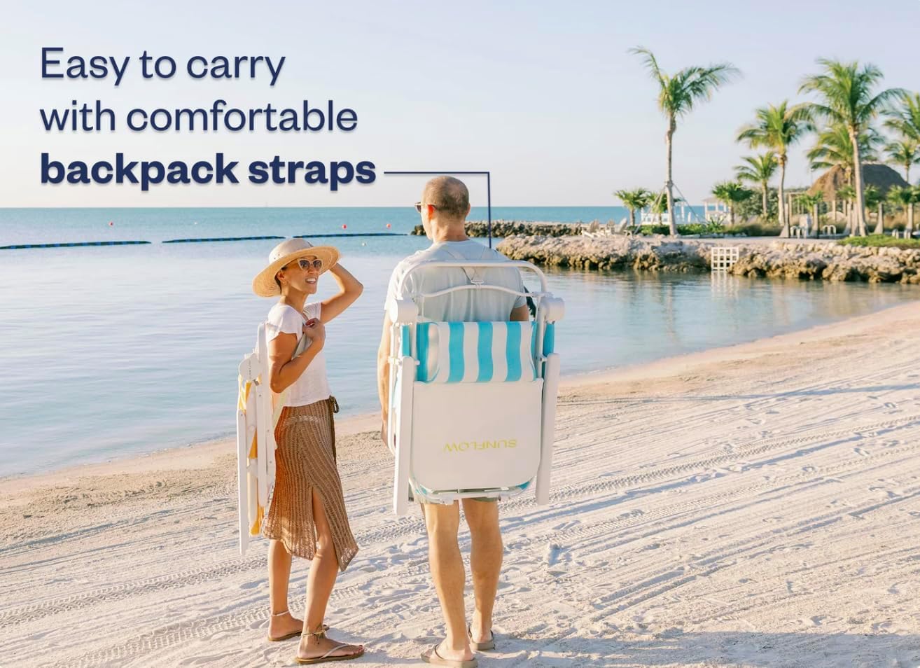 A person carrying the folded SUNFLOW beach chair using its integrated backpack straps on a beach.