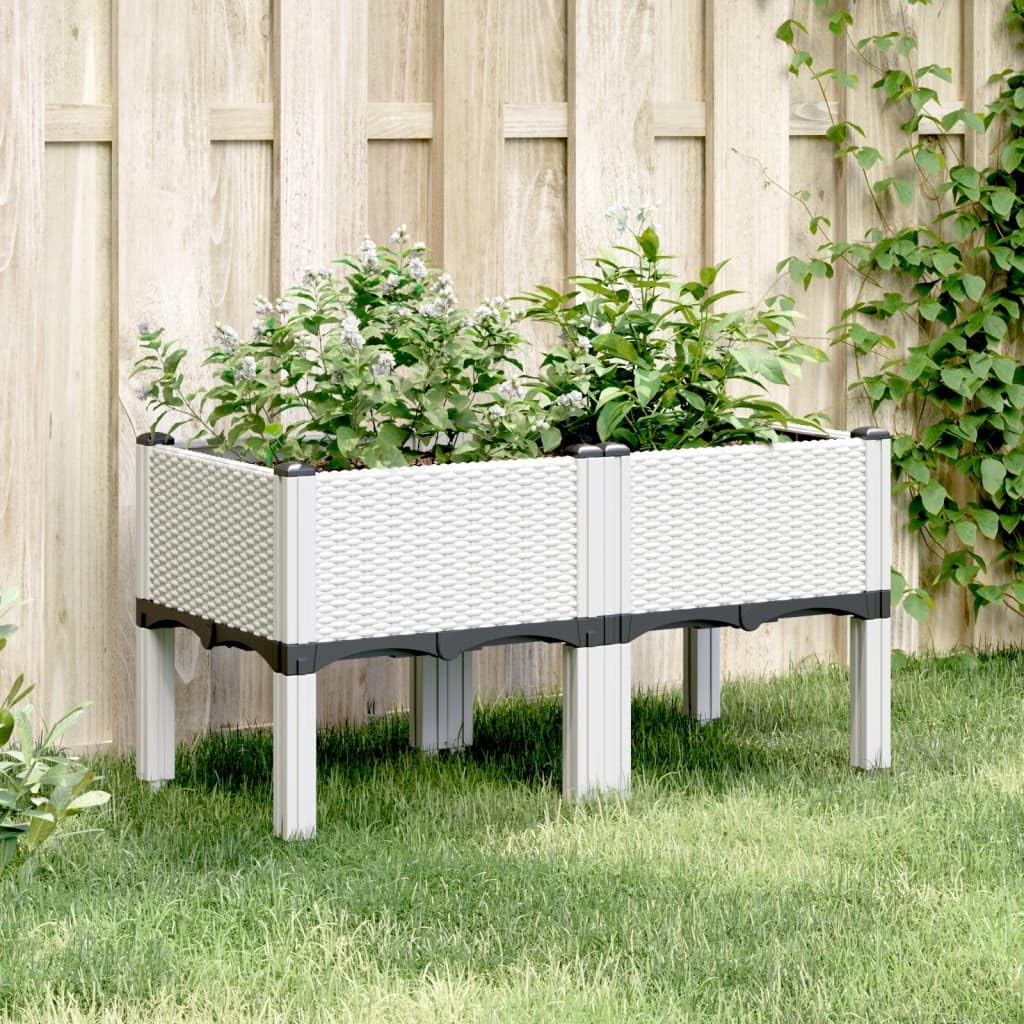 Jardinière en polypropylène aspect rotin avec pieds pour terrasse