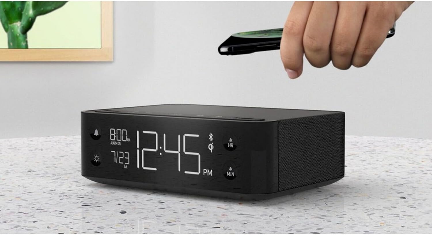 Hand placing a smartphone on the Nonstop NSA2-BK for wireless charging