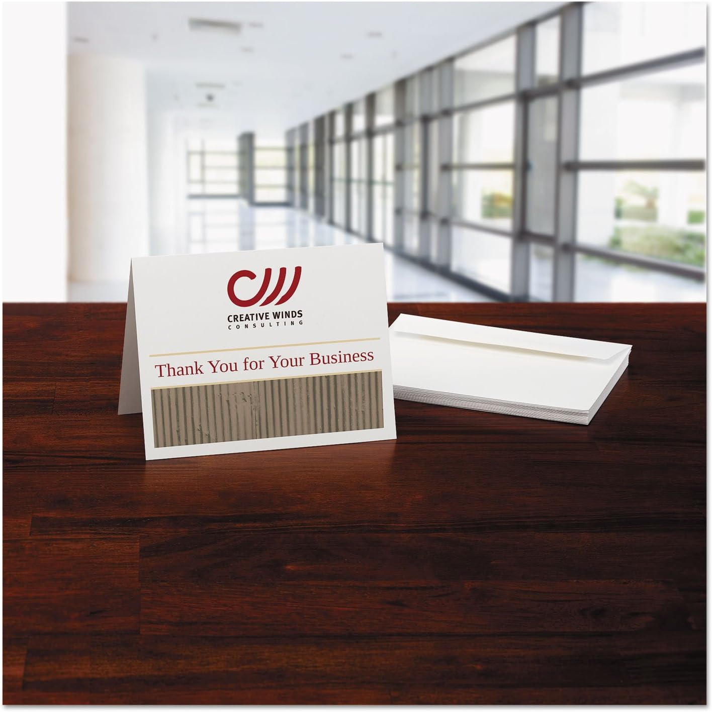 A folded note card with 'Thank You' message and a stack of envelopes