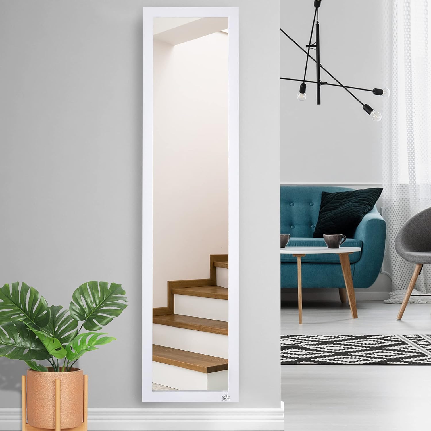 A white full-length mirror mounted flush against a wall in a living room setting, near a staircase.