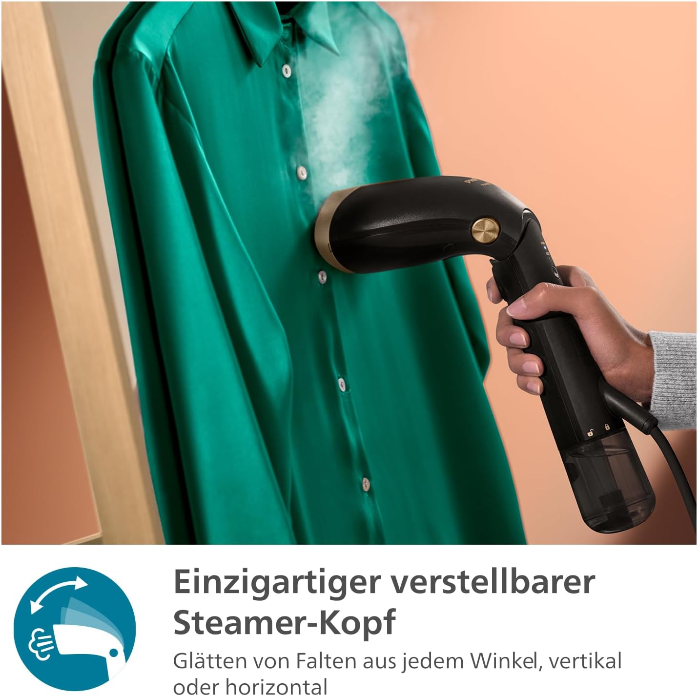 A hand holding the Philips Steamer 7000 Series, with its adjustable head, steaming a green shirt hanging on a hanger. Steam is visible.