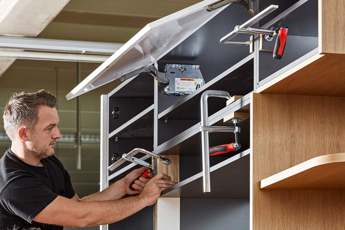 Man using Bessey GZ50-12KG clamp in a cabinet assembly