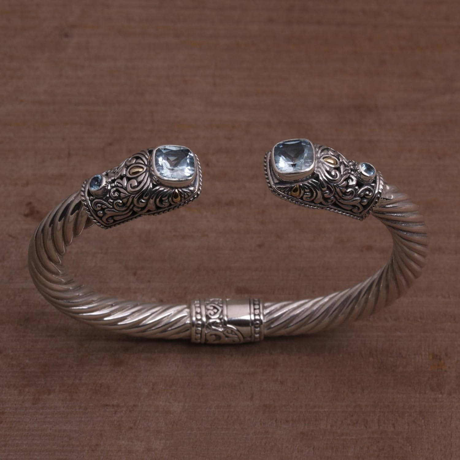 NOVICA Artisan Handmade Blue Topaz Gold Accent Cuff Bracelet Sterling Silver with Accents Tone Indonesia Gemstone Birthstone [6 in L (end to End) x 0.5 in W] ' Dazzling Crest'