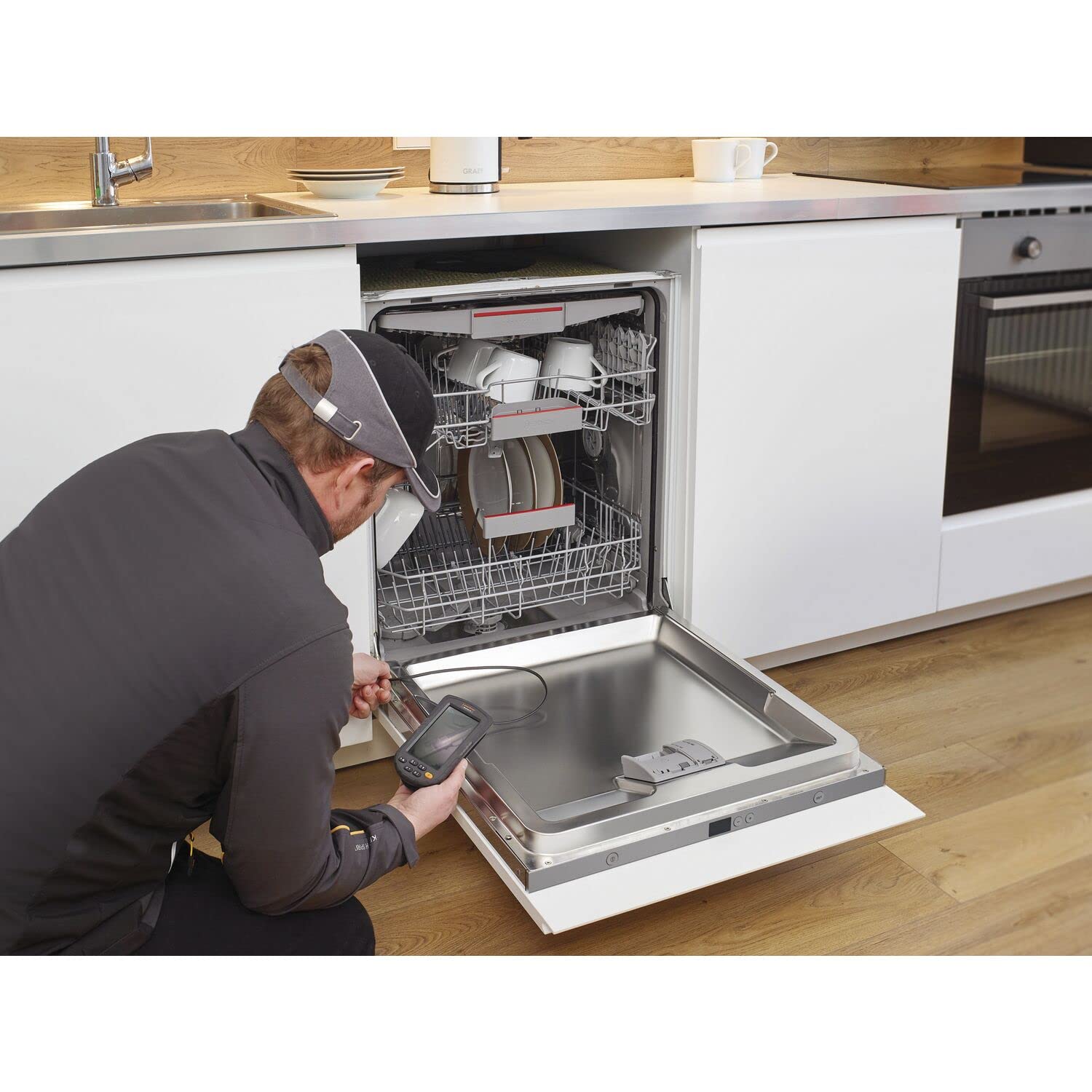 Person using Laserliner inspection camera to inspect a dishwasher
