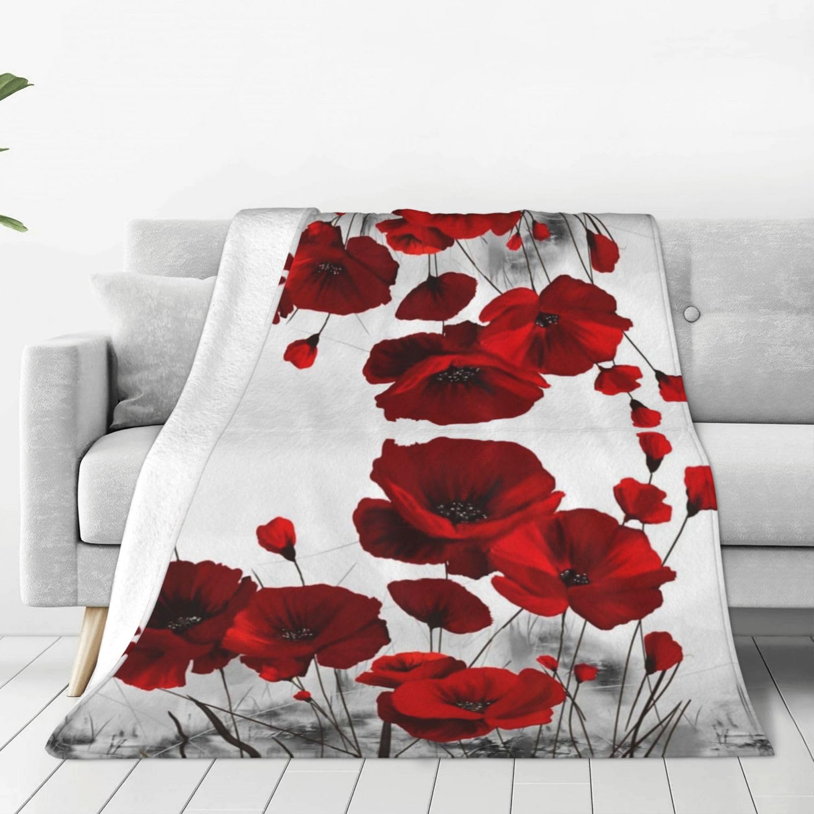 Couverture polaire coquelicots pour ne plus avoir froid sur votre canapé cet hiver