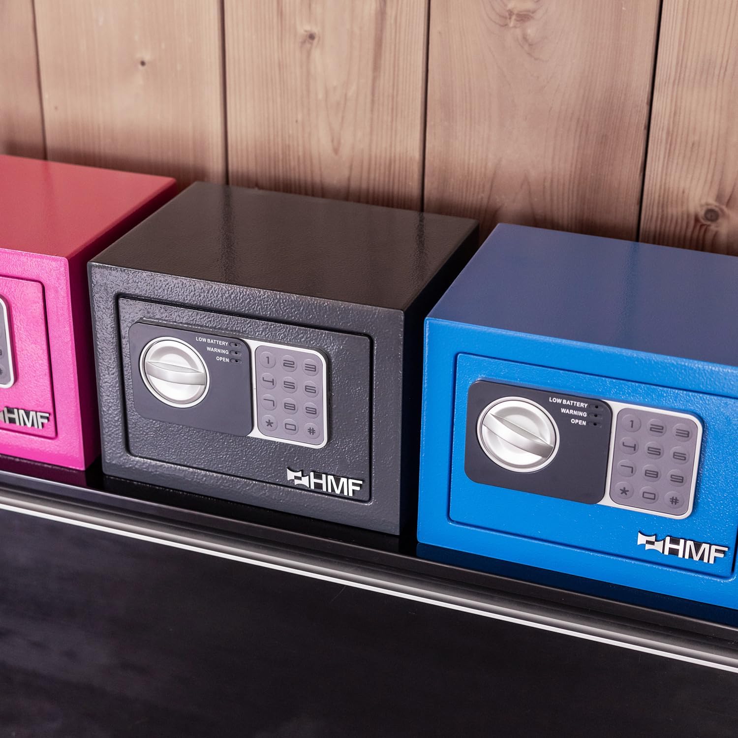 Close-up of the HMF safe's keypad with an emergency key inserted into the hidden keyhole.