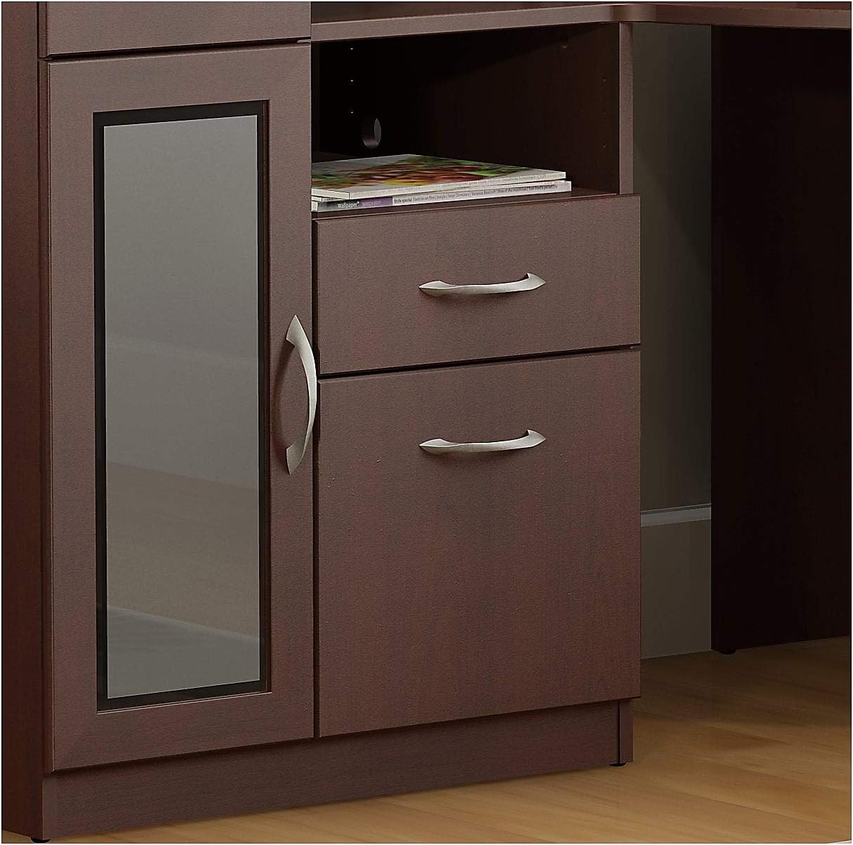 Close-up of the Bush Furniture Vantage Corner Desk drawers and cabinet, showing the polished pewter pulls and frosted glass door.